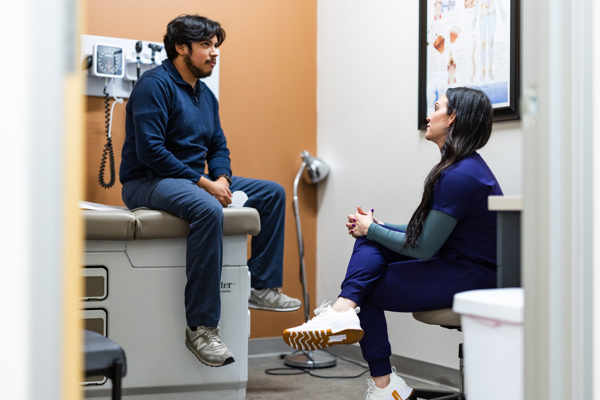 Deedee sitting and talking with a patient in an unhurried exam room at Prime Direct Health