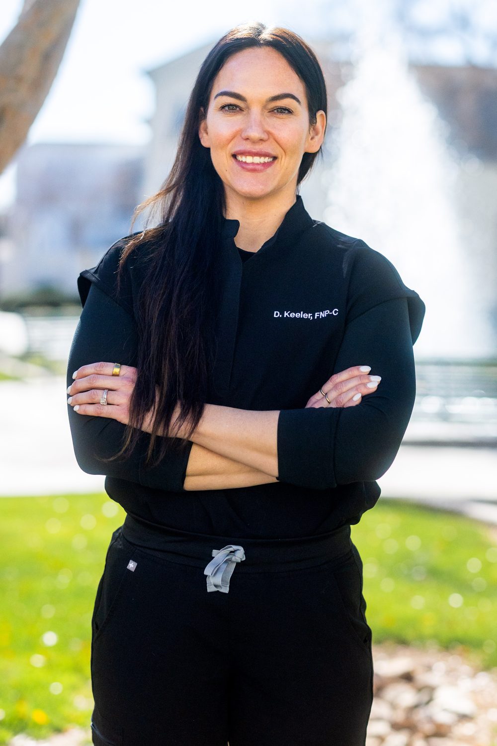 Deedee Keeler, FNP-C, standing outdoors with arms crossed