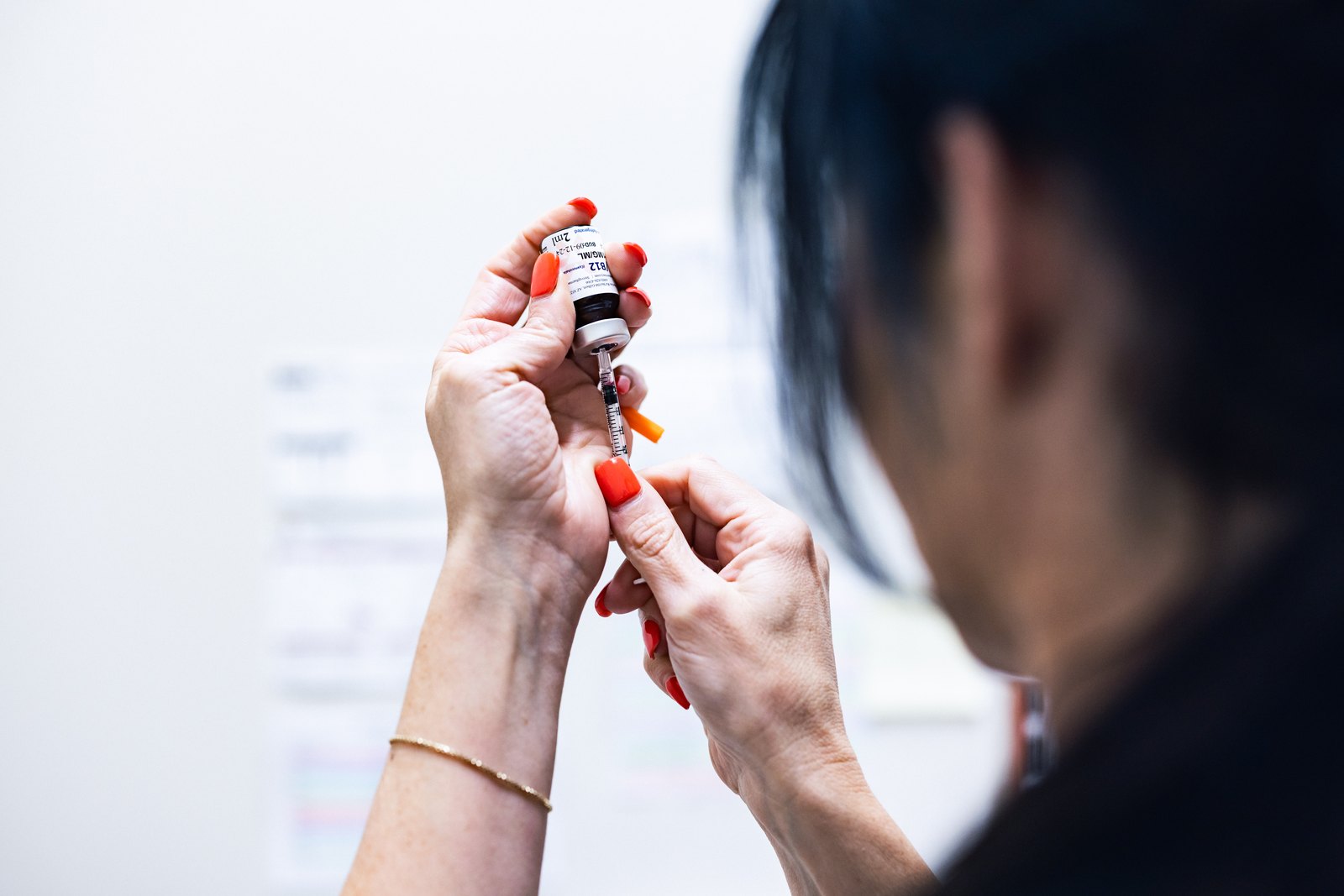 Deedee Keeler drawing medication from a vial at Prime Direct Health in Gilbert