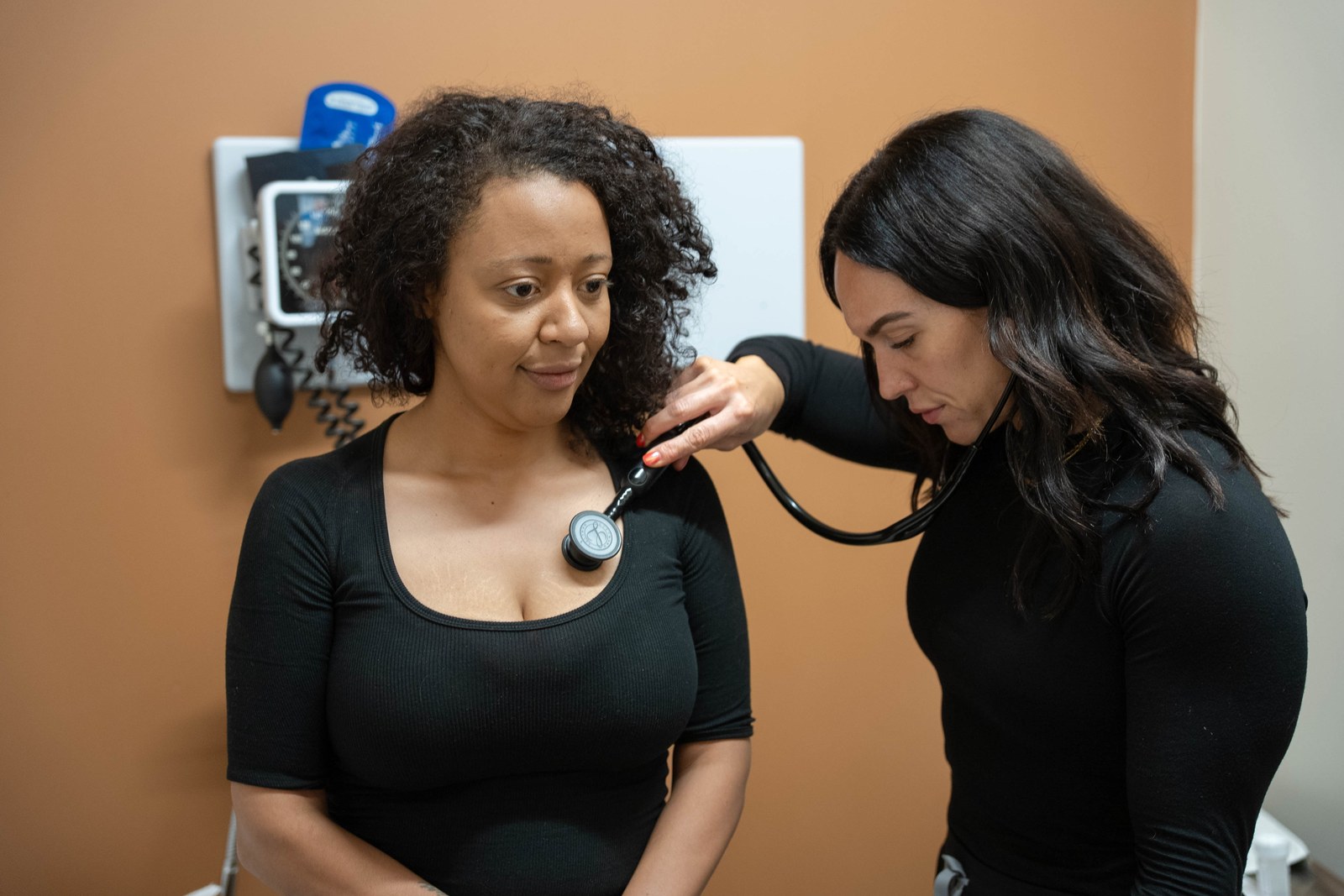 Deedee Keeler listening to a patient's heart during an annual visit at Prime Direct Health in Gilbert